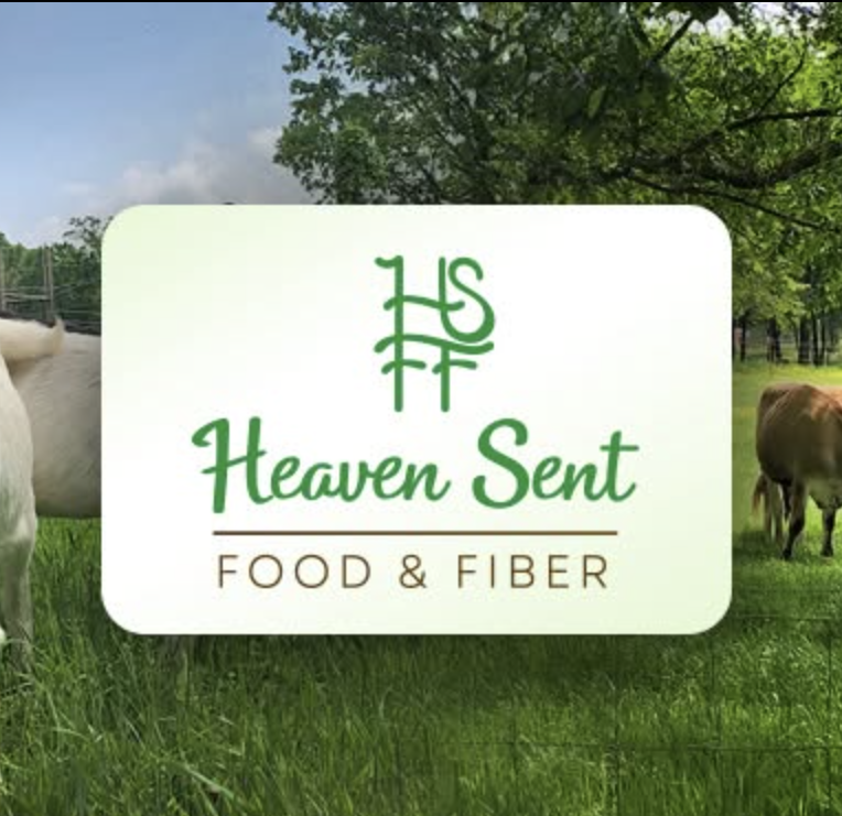 Heaven Sent Food & Fiber featuring a white and black goat on the left, cattle grazing in a green pasture on the right, and a central logo badge.
